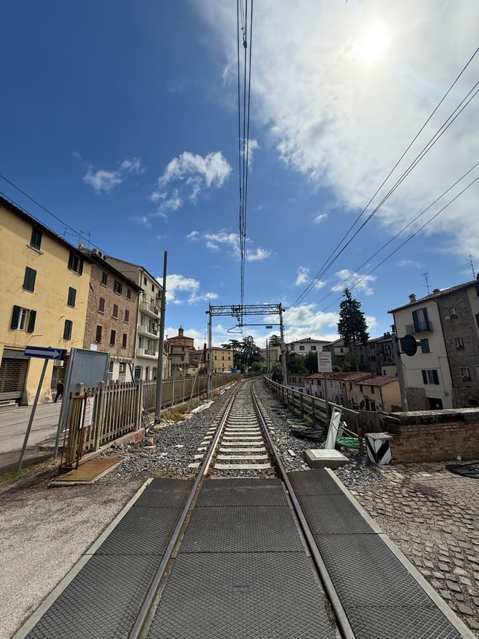 A railway line running between the houses of a hillside town